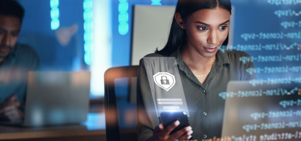 Cybersecurity analyst concentrating on computer screen investigating potential cyber incident