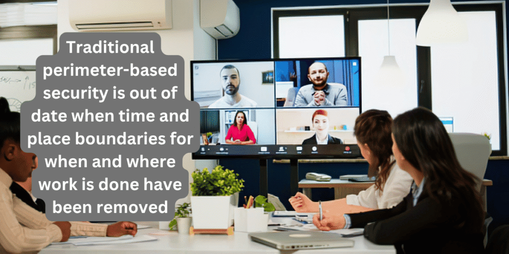 People at a conference table meeting with colleagues who are going online pictured on a computer screen.